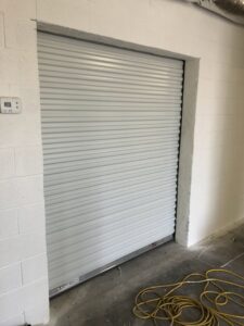 A white commercial roll-up door installed by Valley Overhead Door in Las Vegas, NV.