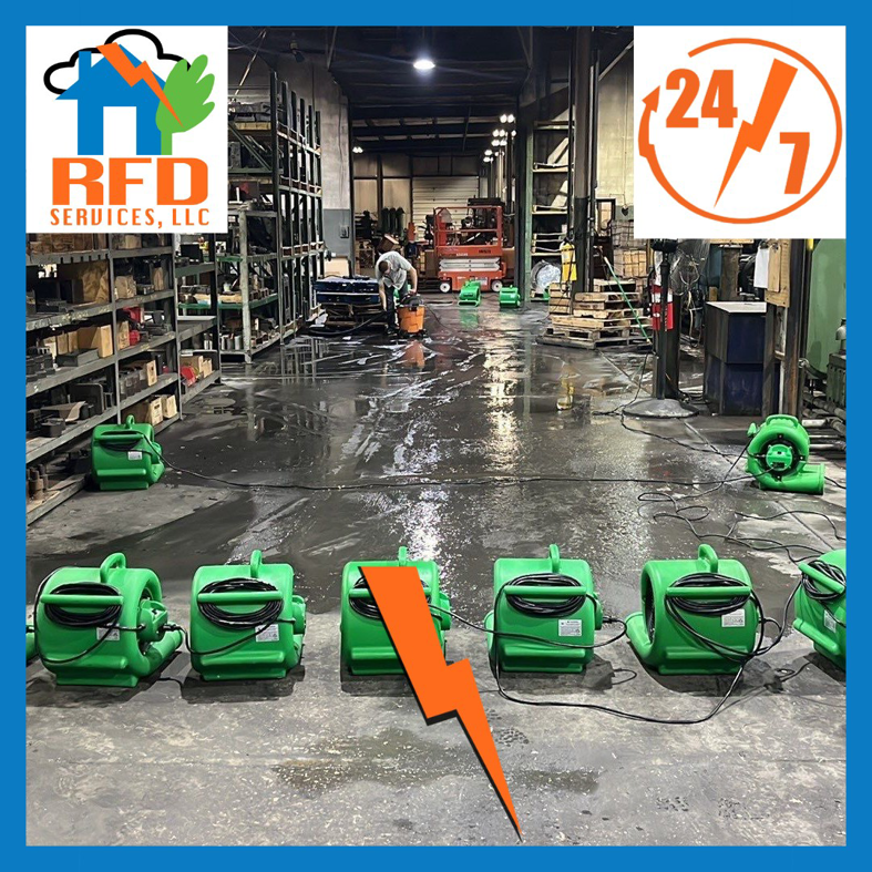 Commercial space with wet floor and multiple air movers for water damage drying by RFD Services in Akron, OH.