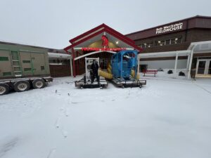 Commercial water damage drying equipment with yellow ducts set up outside Frontier High School by Express Restoration in Edmond, OK.