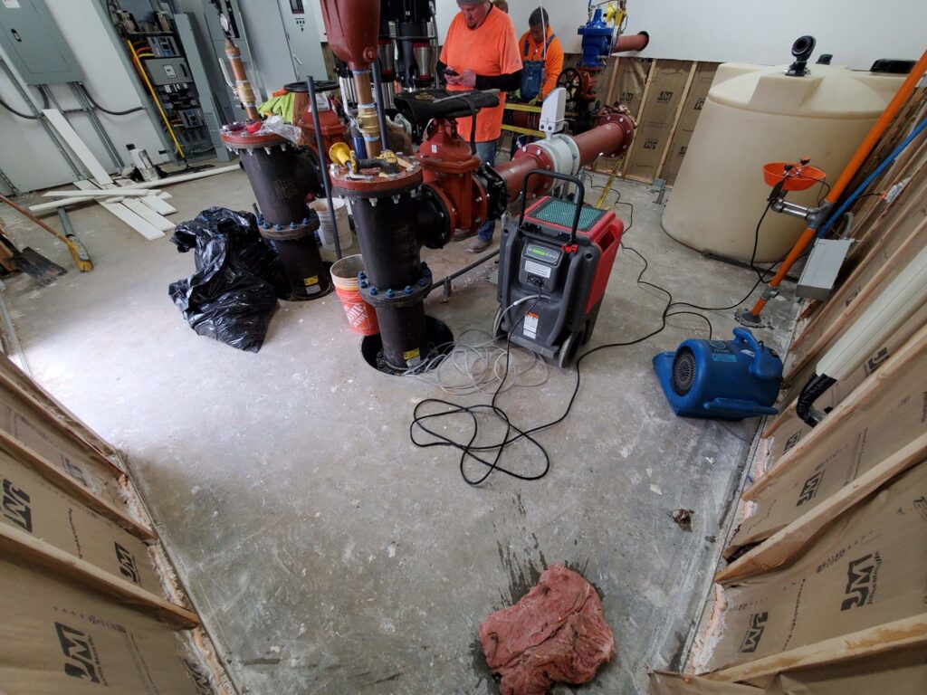 Commercial water damage restoration with drying equipment and large pipes in a facility by Utah Disaster Team in Layton, UT.