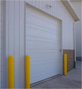 A white commercial garage door installation by Garage Door Services, Inc. in Omaha, NE.