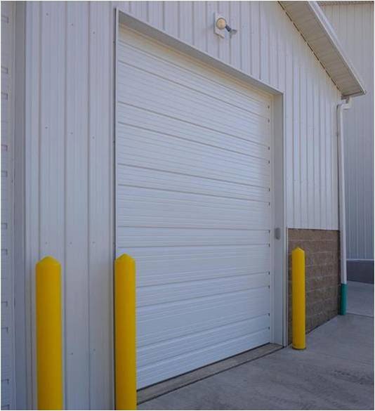A white commercial garage door installation by Garage Door Services, Inc. in Omaha, NE.