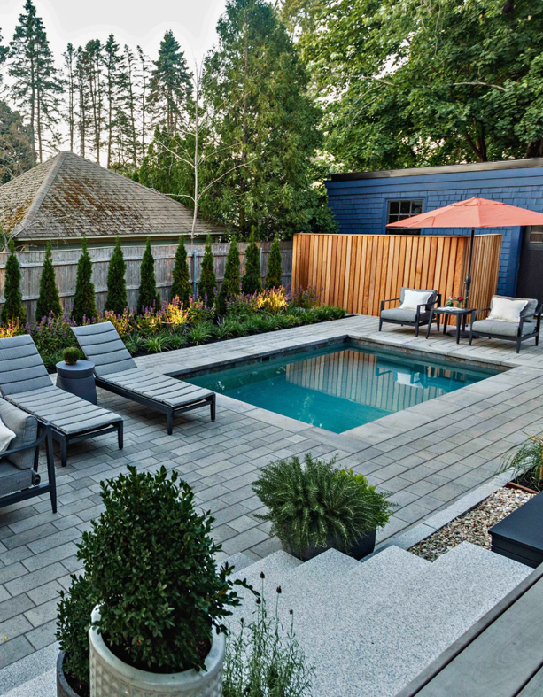 A compact modern inground pool surrounded by a paver patio and lounge chairs by Christman Pool Service in Portland, ME.