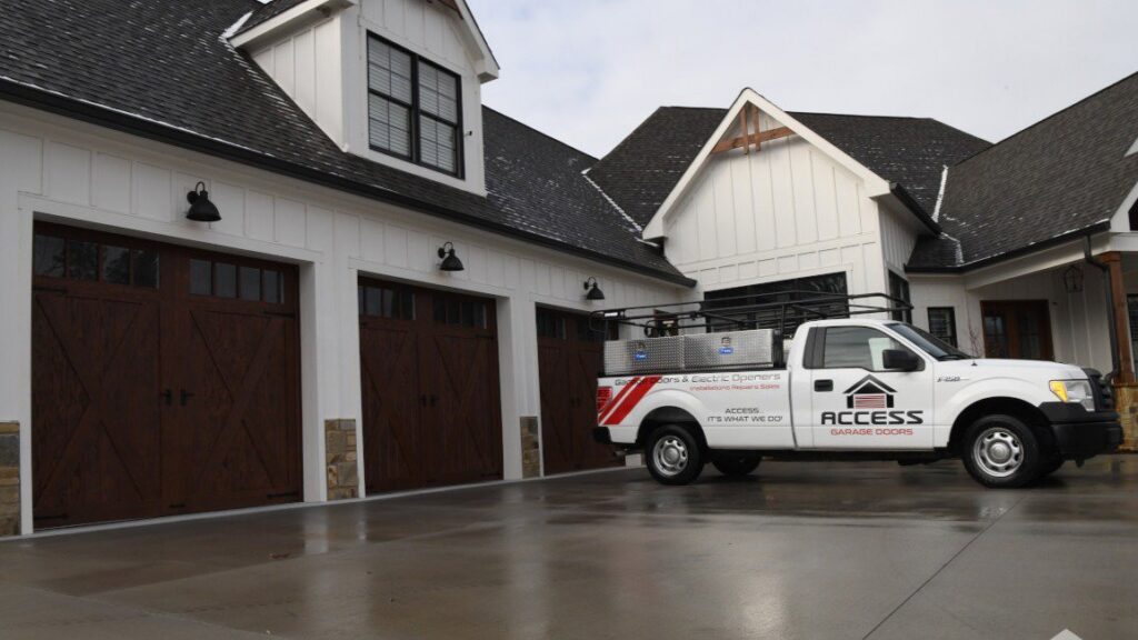 Access Garage Doors of Treasure Valley company truck parked in front of a home with newly installed garage doors in Meridian, ID.