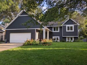 A beautiful home with newly installed dark gray siding and white trim, completed by Archcraft Exteriors in South Saint Paul, MN.