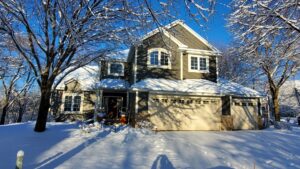 A house with newly installed dark gray siding, surrounded by snow in winter, completed by Archcraft Exteriors in South Saint Paul, MN.