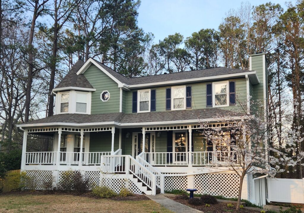 A beautiful home with newly installed green siding and white trim by HP Exteriors in Woodstock, GA