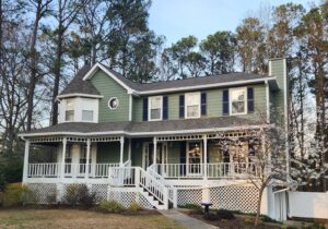 A beautiful home with newly installed green siding and white trim by HP Exteriors in Woodstock, GA