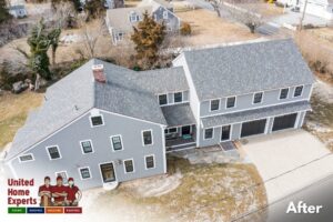 A completed home renovation with new grey siding and roofing by United Home Experts in Ashland, MA.