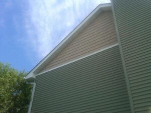 Completed house siding project with new green and beige siding by Capital Siding, Windows & Roofing, Woodbury, MN.