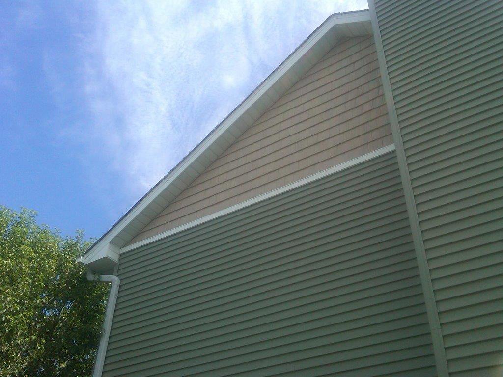 Completed house siding project with new green and beige siding by Capital Siding, Windows & Roofing, Woodbury, MN.