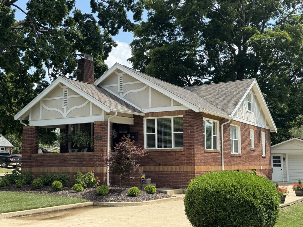 A beautifully completed house siding project featuring brick and decorative trim by Freeman Exteriors in Danville, IL.