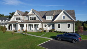 A beautifully completed large house featuring gray shingle and horizontal siding by JM Roofing & Siding in Rogers, AR.