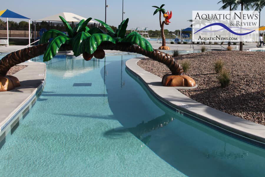 A beautifully completed lazy river style pool with artificial palm trees, showcasing work by ACL Consultant in Edmond, OK