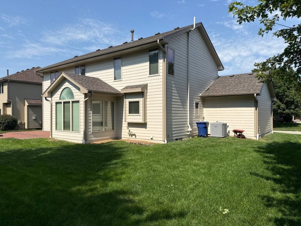 A residential home showcasing newly installed light beige siding, a completed project by Bishop Exteriors in Omaha, NE.