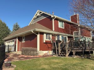 A beautifully completed red and gray siding project on a residential home by Bishop Exteriors in Omaha, NE.