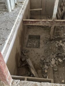 A large rectangular opening cut into a concrete floor, demonstrating demolition expertise by Valute Demolition in Jacksonville, FL.