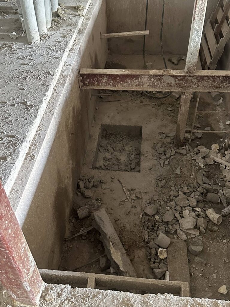 A large rectangular opening cut into a concrete floor, demonstrating demolition expertise by Valute Demolition in Jacksonville, FL.