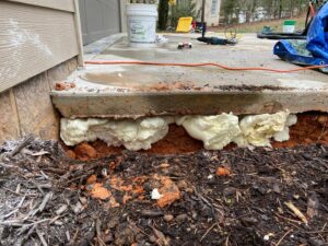Polyjacking foam injected under a concrete slab for slab lifting by HNO Waterproofing & Slab Lifting Pros in Concord, NC.