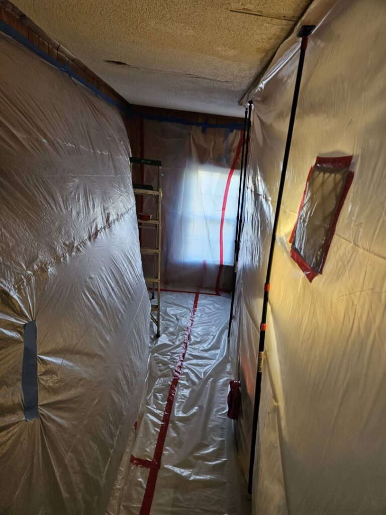 A contained area with plastic sheeting set up for mold or water damage remediation by AdvantaClean of Cabarrus and Rowan Counties in Concord, NC.