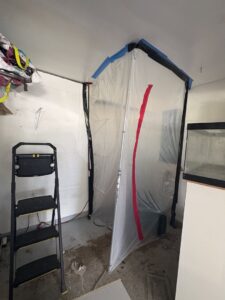 A plastic containment area set up for mold or water damage remediation by Catalyst Restoration in Hagerstown, MD.