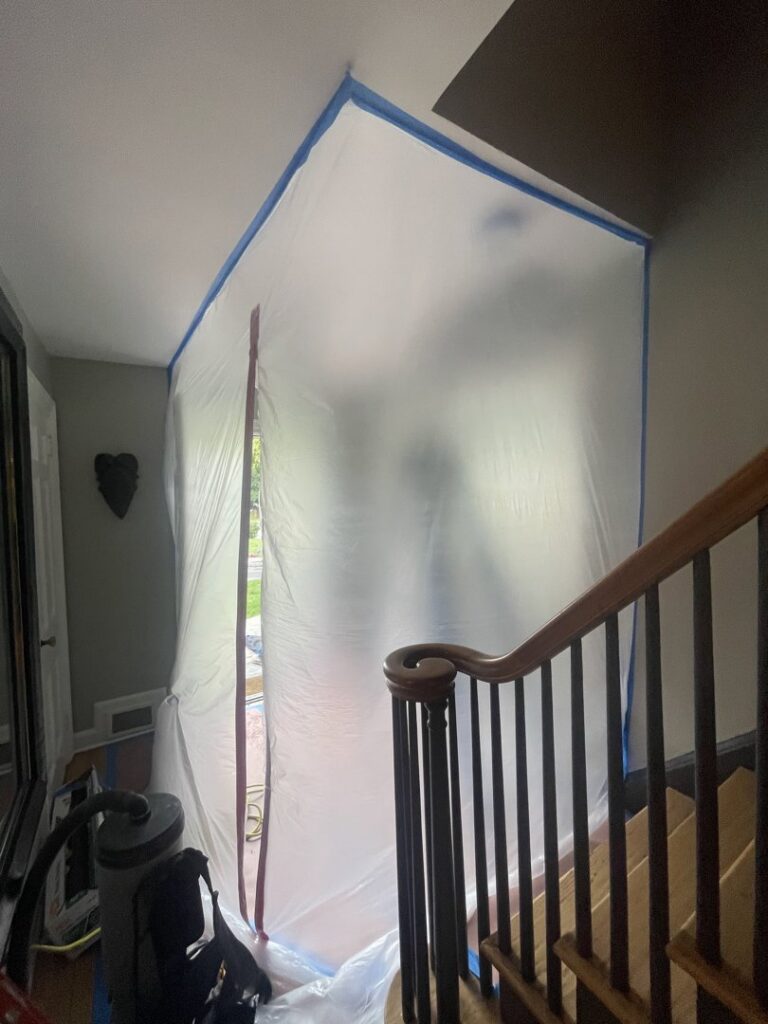 A containment area created with plastic sheeting during a water damage or mold remediation job by NSH Home Services in Jersey City, NJ.