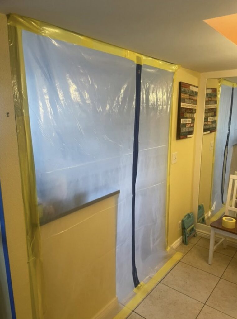 A plastic containment barrier set up in a home, a common practice during water damage restoration or mold remediation by Standard Restoration in Salt Lake City, UT.