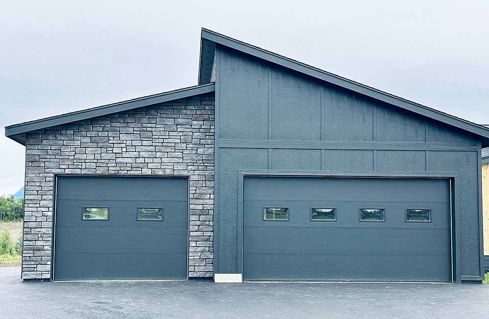 Contemporary dark grey garage doors with small windows installed by Elite Doors in Wasilla, AK.