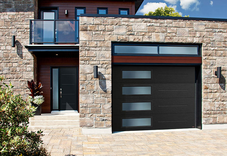 A contemporary home featuring a sleek black garage door with windows, installed by Sawtooth Garage Doors in Boise, ID.