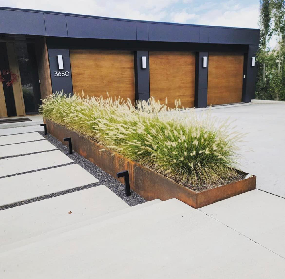 A contemporary home showcasing three elegant wood-look garage doors from Windsor Door Sales Inc. in Ogden, UT.