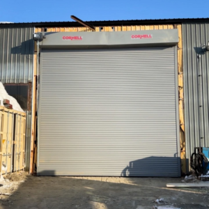 A Cornell commercial roll-up garage door installed by Alaska Door in Wasilla, AK, on a metal building.