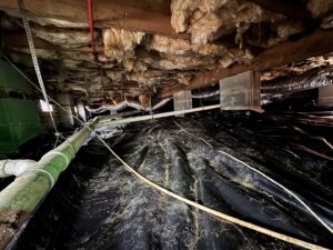 Crawl space encapsulation with a black vapor barrier for moisture control by Carolina Pro Restoration LLC in Fort Mill, SC.