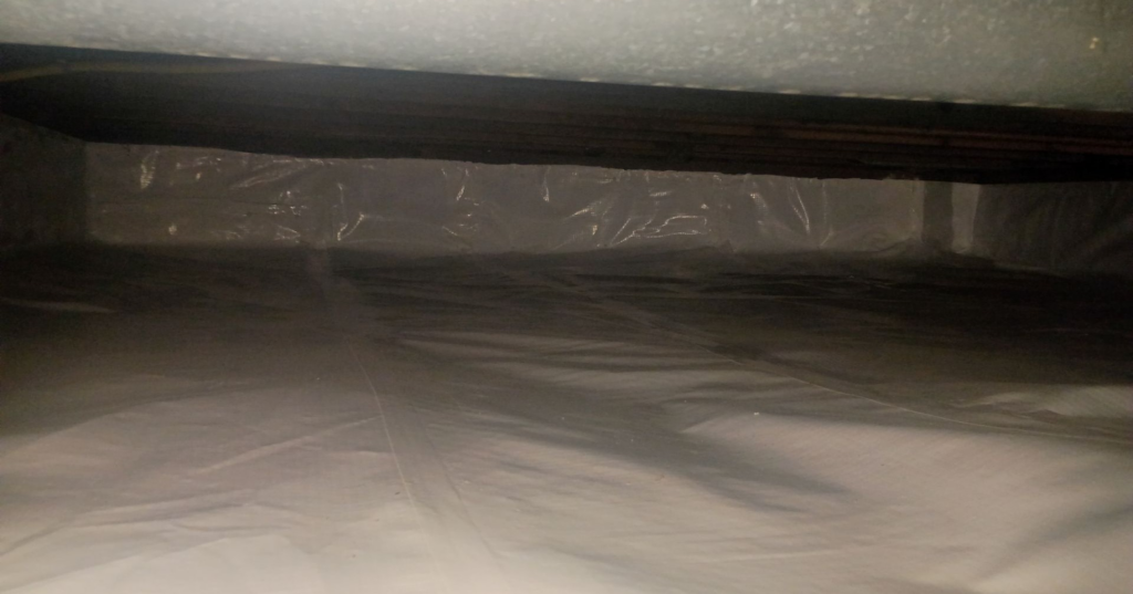 A clean crawl space with a white vapor barrier installed for encapsulation by Tomlinson Cannon in Iowa City, IA.
