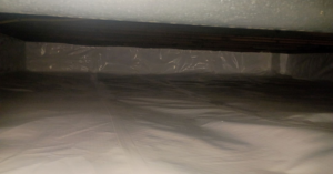 A clean crawl space with a white vapor barrier installed for encapsulation by Tomlinson Cannon in Iowa City, IA.