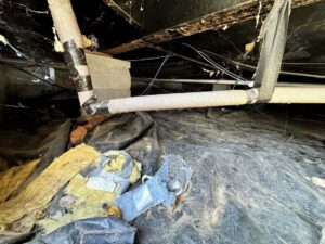 Crawl space with insulation and a new moisture barrier installed by Carolina Pro Restoration LLC in Fort Mill, SC.