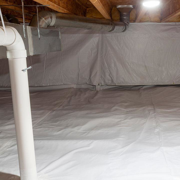 A clean crawl space with a white vapor barrier installed for moisture control by AdvantaClean of Cabarrus and Rowan Counties in Concord, NC.