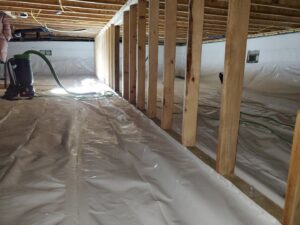 A newly installed vapor barrier in a crawl space during water damage restoration by Brothers Restoration in Post Falls, ID.