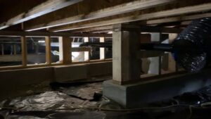 Crawl space with plastic vapor barrier and drying equipment for water damage by Complete Restoration and Construction, LLC in Yakima, WA