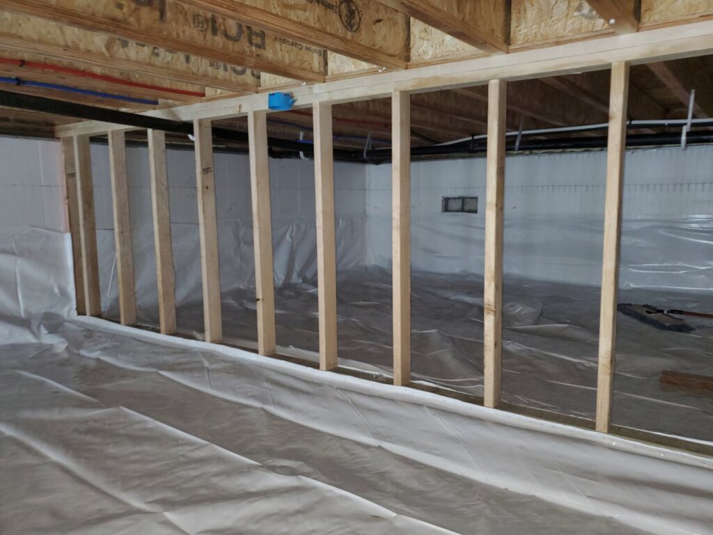 A clean crawl space with new waterproofing and vapor barrier installed by Brothers Restoration in Post Falls, ID.