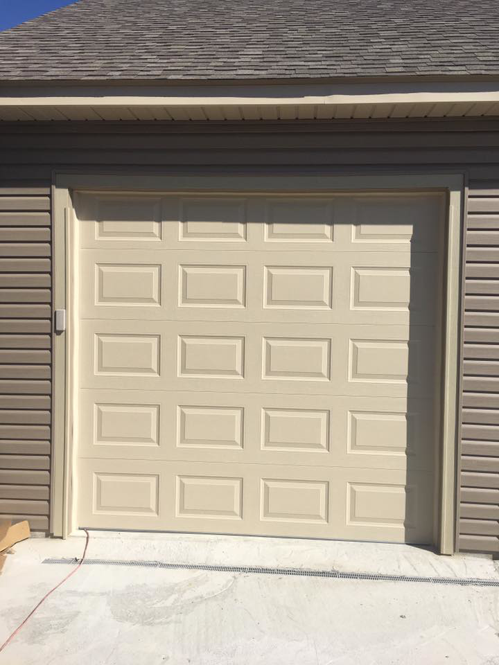 A cream-colored raised panel garage door installed by Advantage Door Company in Troy, MO.