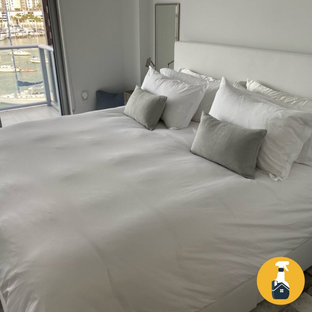 A crisp white bedroom with a marina view from the balcony, expertly cleaned by The Prime Cleaner in Miami, FL.