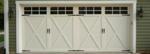 A beautiful custom-style white garage door with windows and decorative hardware installed by Carriage Overhead in Stamford, CT.