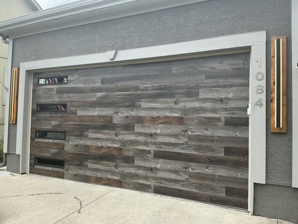 A custom wood plank style garage door with modern windows installed by ABC Garage Doors KC in Kansas City, KS.