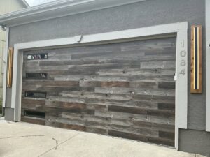 A custom wood plank style garage door with modern windows installed by ABC Garage Doors KC in Kansas City, KS.
