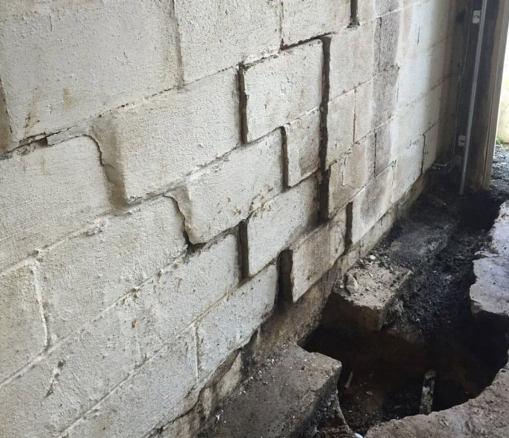 Damaged concrete block basement wall with a waterproofing trench by Waterdry Indiana in South Bend, IN