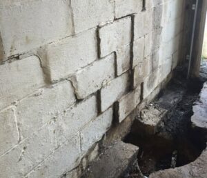 Damaged concrete block basement wall with a waterproofing trench by Waterdry Indiana in South Bend, IN