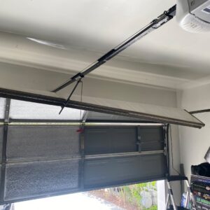 A damaged and bent garage door requiring repair, illustrating a common service provided by American Veteran Garage Door Repair Henderson, NV.