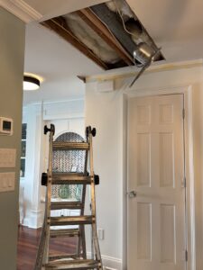 A damaged ceiling with exposed insulation and wiring, indicating water leak repair work by Homcertin llc in Trenton, NJ.