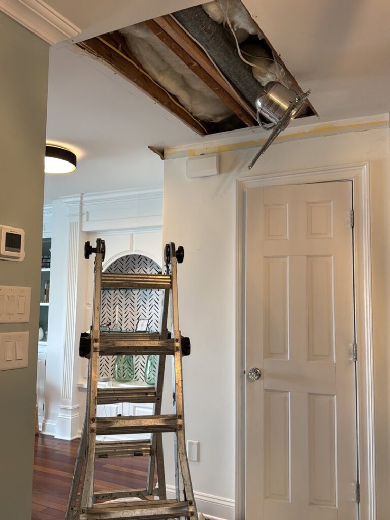A damaged ceiling with exposed insulation and wiring, indicating water leak repair work by Homcertin llc in Trenton, NJ.