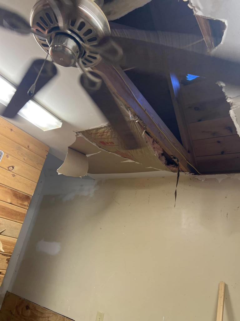 A severely damaged ceiling with a large hole and exposed insulation, indicating water damage or structural failure, ready for repair by Bullseye Home Services in Southaven, MS.